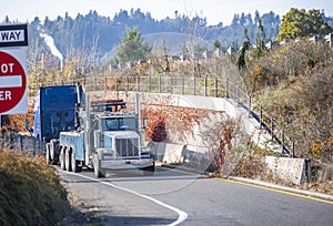 Powerful tow truck towing brocken big rig semi truck to repair shop