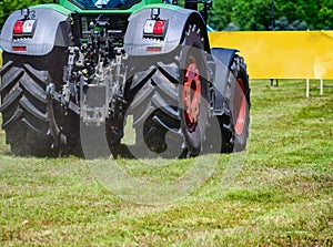 Powerful tractor wheels go over the ground up dust.A small movement effect