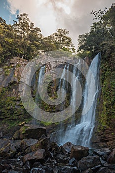 Powerful waterfall on the rocks in the middle of the jungle in the tropics of Costa Rica, Baru River photo