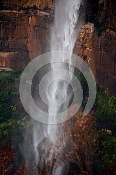 Powerful waterfall tumbling over sandstone cliffs