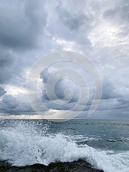 A powerful wave crashes against the rocks