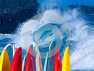 Powerful waves break at Lumahai Beach, Kauai with Surfboards