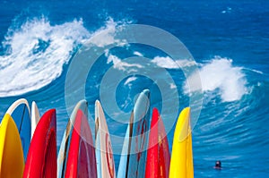 Powerful waves break at Lumahai Beach, Kauai with Surfboards