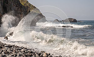 Powerful waves break on rocks in the sea