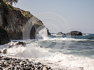 Powerful waves break on rocks in the sea