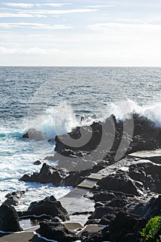 Powerful waves crash along the shoreline of Cinco Ribeiras. photo