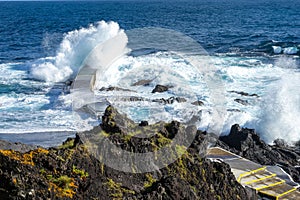 Powerful waves crash along the shoreline of Cinco Ribeiras. photo