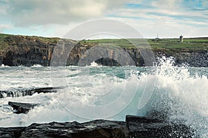 Powerful waves crushing against Cliffs and rough stone coastline of West coast of Ireland. Doolin area. County Clare. Ocean power