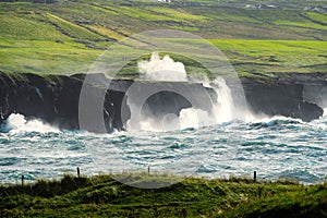 Powerful waves crushing against Cliffs and rough stone coastline of West coast of Ireland. Doolin area. County Clare. Ocean power