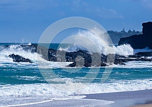 Powerful waves flow over rocks at Lumahai Beach, Kauai