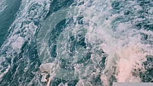 Powerful waves following the ship. Track from the engines of the ship. Cruise liner sails on the blue ocean. Waves behind the ste