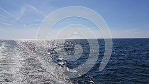 Powerful waves following the ship. Waves behind the stern of the ship. Track from the engines of the ship.