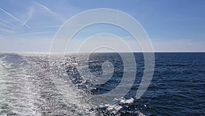 Powerful waves following the ship. Waves behind the stern of the ship. Track from the engines of the ship.