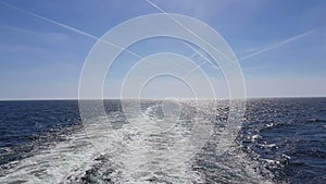 Powerful waves following the ship. Waves behind the stern of the ship. Track from the engines of the ship.