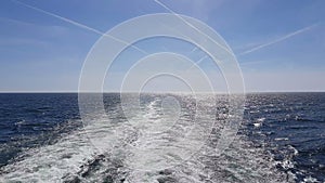 Powerful waves following the ship. Waves behind the stern of the ship. Track from the engines of the ship.