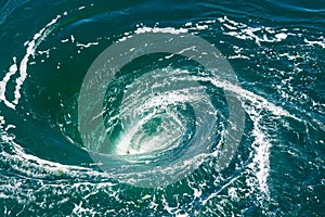 A powerful whirlpool at the surface of the sea