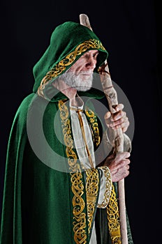 Powerful wizard holds a wooden magic staff