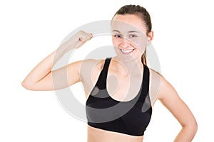 Powerful young fit slim woman on white background posing showing biceps