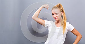 Powerful young fit woman flexing