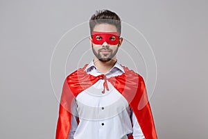 Powerful young unshaven business man in shirt superhero suit have supernatural abilities isolated on grey background