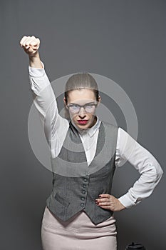 Powerful young woman with a fist to the sky