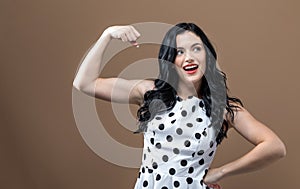 Powerful young woman in success pose