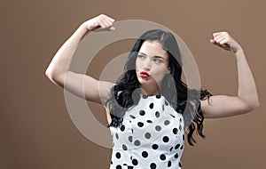 Powerful young woman in success pose