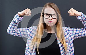 Powerful young woman in success pose