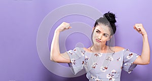 Powerful young woman in a success pose