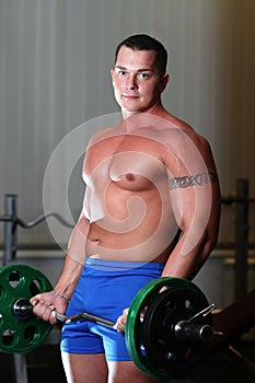 Powerlifter with barbell in gym