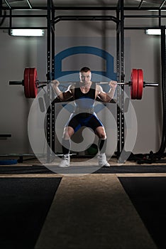 Powerlifter Doing Exercise For Legs With Barbell