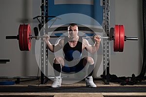 Powerlifter Doing Exercise For Legs With Barbell