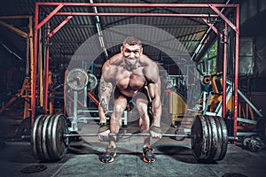 Powerlifter with strong arms lifting weights photo