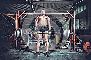 Powerlifter with strong arms lifting weights photo