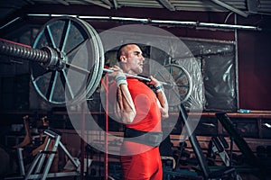 Powerlifter with strong arms lifting weights photo