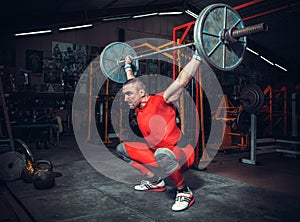 Powerlifter with strong arms lifting weights photo