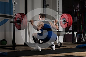 Powerlifter Doing Exercise For Legs With Barbell photo