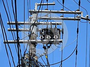 Powerline insulators, connectors and tangled wires on an electrical pole