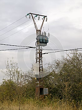 Powerline pole with isolators in a forest area