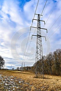 powerline in silhouette on cloudy light sky