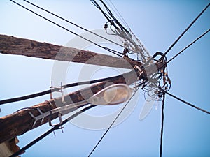 Powerlines and streetlamp on wooden poles