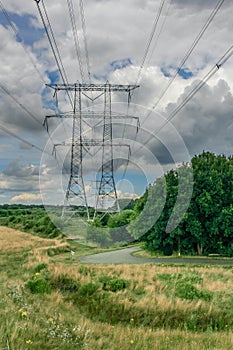Powermast in a rural landscape with powerful clouds overhead