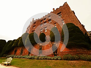 Powys Castle was originally a medieval castle, later rebuilt into a chateau, surrounded by Baroque gardens.