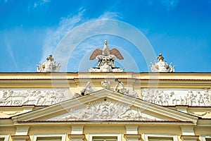 Poznan, Poland - August 09, 2021. Statues on the roof of Kornicka Library - Biblioteka Kornicka in Palac Dzialynskich with protect photo