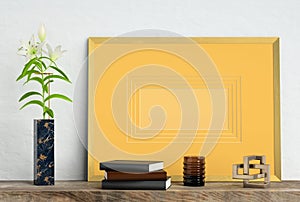 Golden mock up picture frame on white plaster wall with lily flower in marble vase, books, geometric sculpture and vase, 3d illust