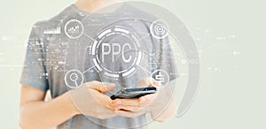 PPC - Pay per click concept with man using a smartphone