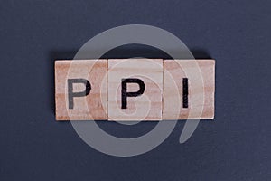 PPI Payment Protection Insurance from wooden letters on a gray background