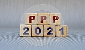 PPP 2021 - word on wooden cubes on a gray background