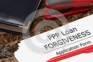 PPP loan forgiveness text on application form paper. Small Business Payroll Protection Program