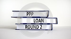 PPP, paycheck protection program loan round 2 symbol. Concept words PPP loan round 2 on books on white background. Business, PPP